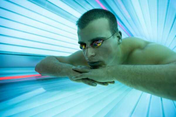 Man in UV Tanning Bed at Elite Training Facility
